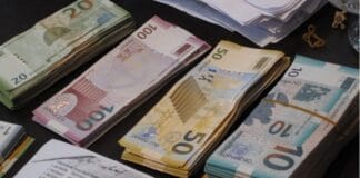 Stacked Azerbaijani manat banknotes displayed.