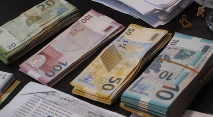 Stacked Azerbaijani manat banknotes displayed.
